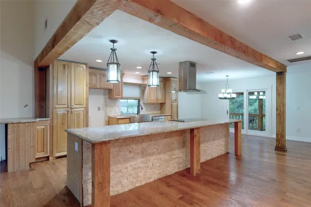 a kitchen with stainless steel appliances granite countertop a sink and a refrigerator