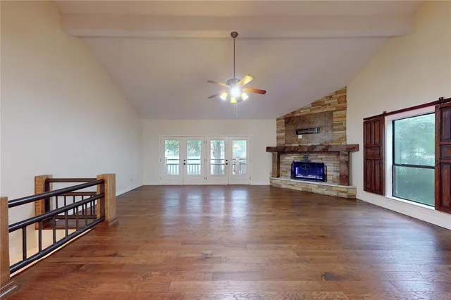 a view of an empty room with window and fireplace