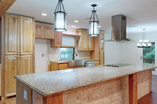 a kitchen with stainless steel appliances granite countertop a sink refrigerator and microwave