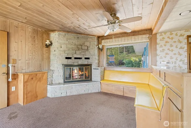 a view of an empty room with a fireplace and a window