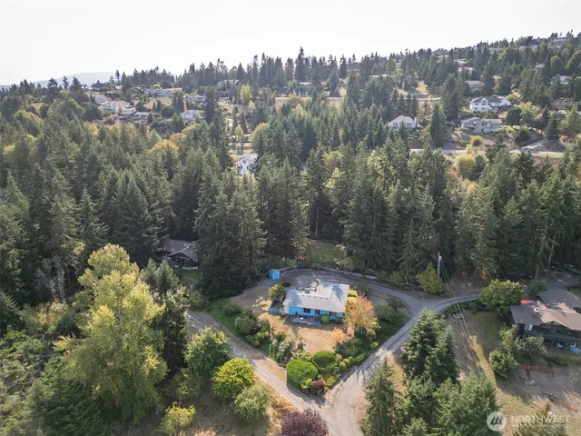an aerial view of a house with a yard
