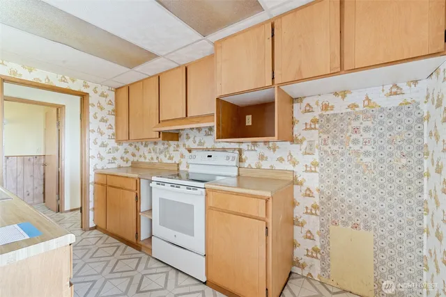 a kitchen with cabinets stainless steel appliances a sink and a stove top oven