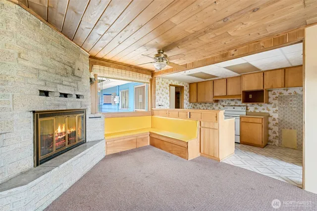 a open kitchen with cabinets a sink and a stove