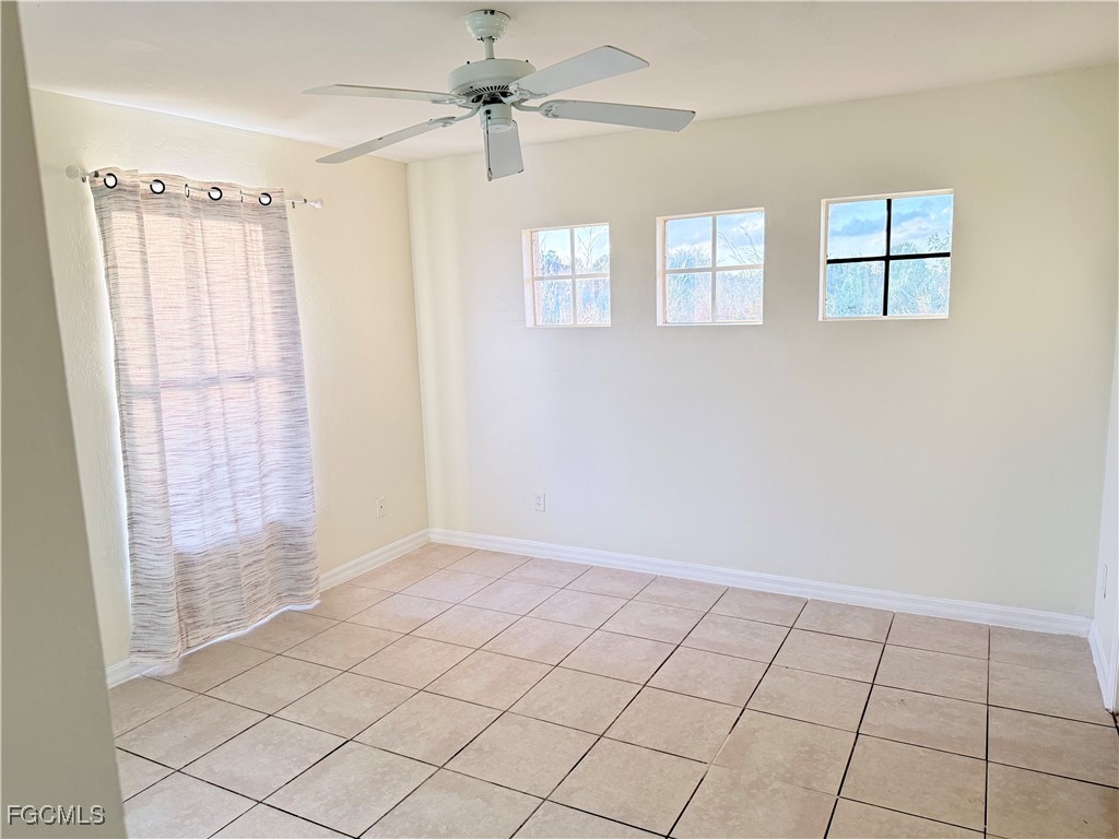 4731 24th Street Southwest Lehigh Acres, FL 33973 - Photo 5 of 8 a view of an empty room and window