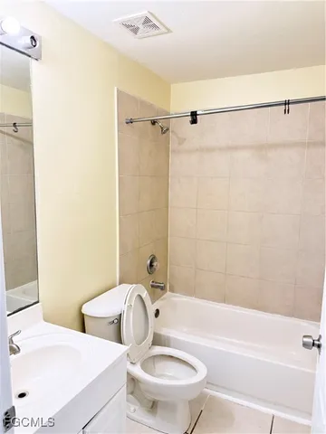 a bathroom with a toilet sink and shower