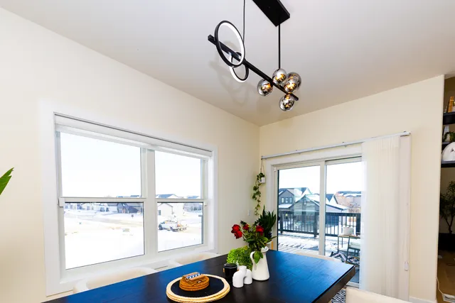 a kitchen with a refrigerator and a potted plant