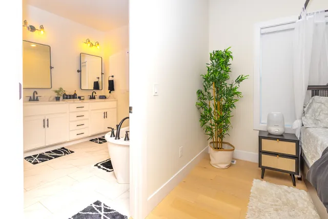 a bedroom with furniture and a potted plant