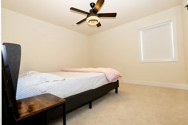a view of wooden house with a chairs and table in a balcony