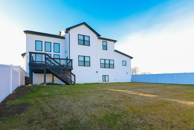 a view of a house with a yard and sitting area