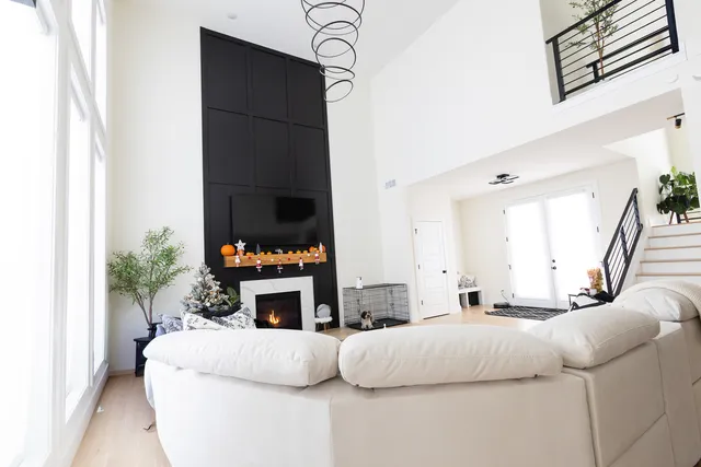 a living room with fireplace furniture and a potted plant
