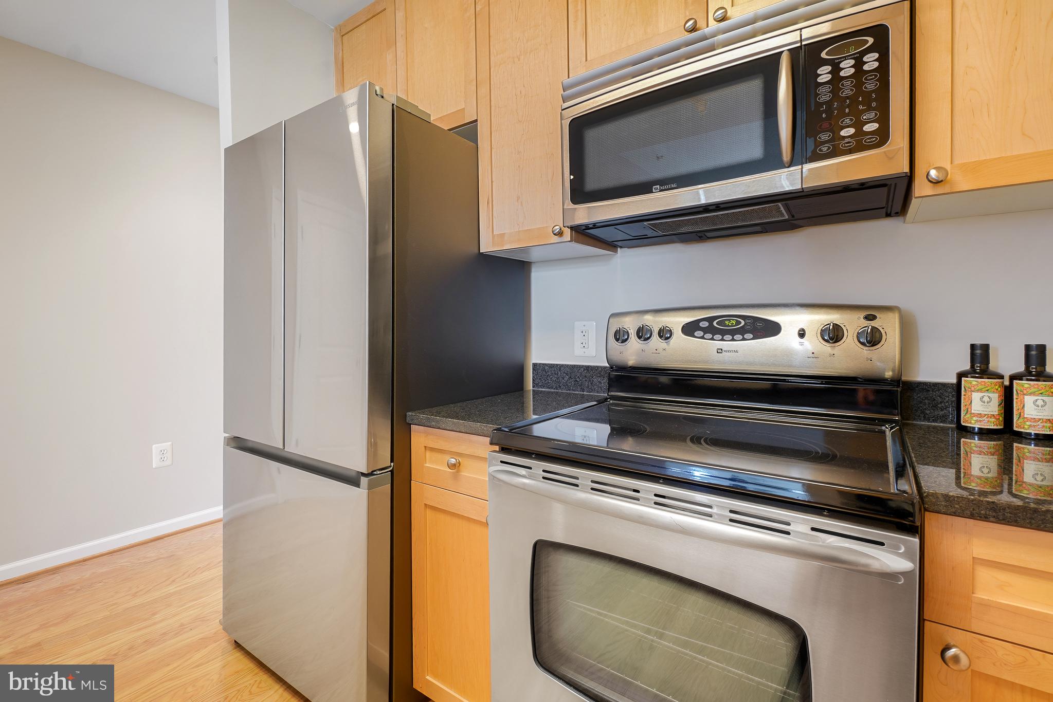 11700 Old Georgetown Road, Unit 214 Rockville, MD 20852 - Photo 13 of 44 a kitchen with appliances and a microwave