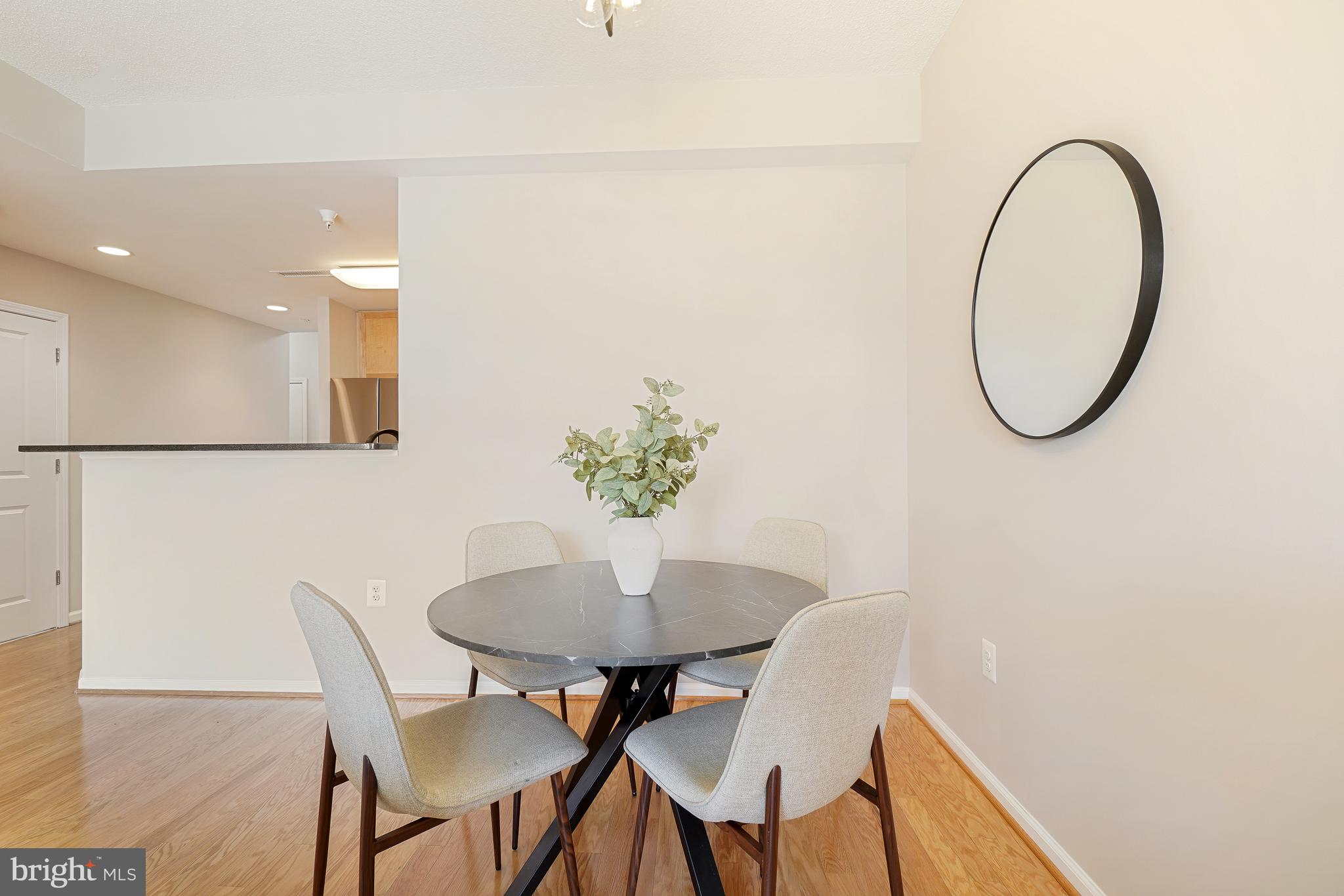11700 Old Georgetown Road, Unit 214 Rockville, MD 20852 - Photo 17 of 44 a dining room with furniture and a potted plant