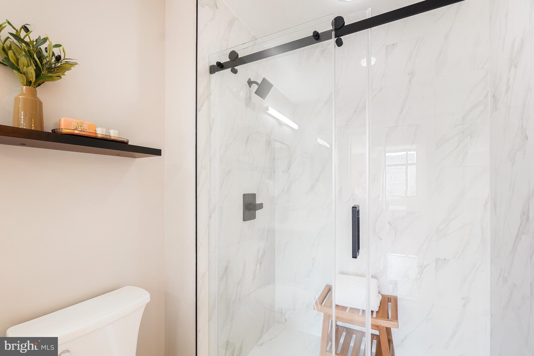 11700 Old Georgetown Road, Unit 214 Rockville, MD 20852 - Photo 33 of 44 a bathroom with a shower and a toilet