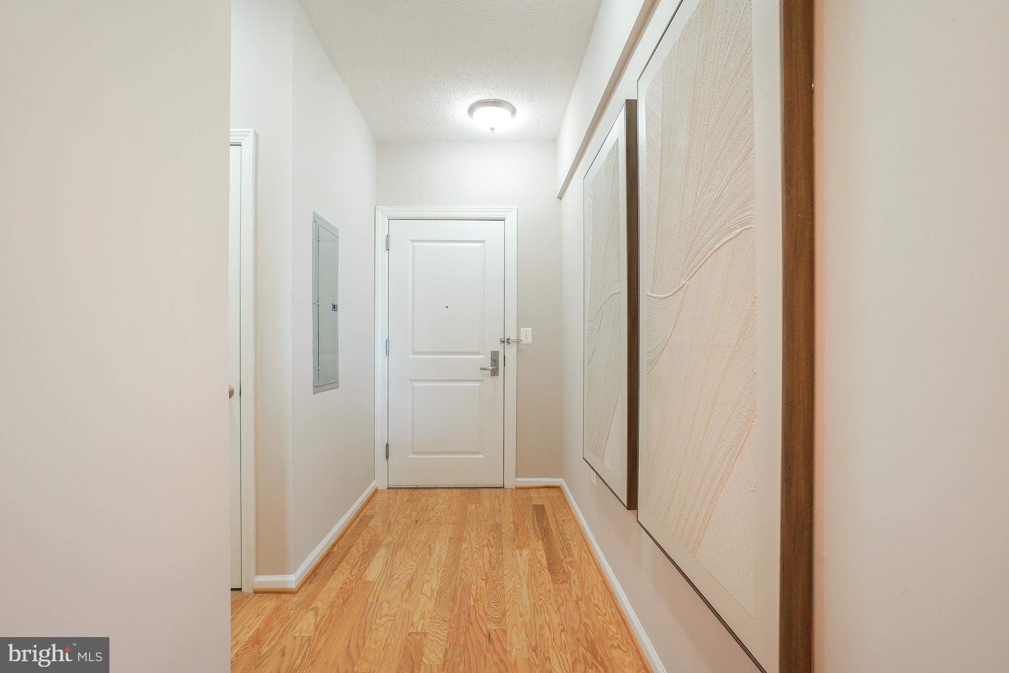 11700 Old Georgetown Road, Unit 214 Rockville, MD 20852 - Photo 8 of 44 a view of a hallway with wooden floor and a bathroom