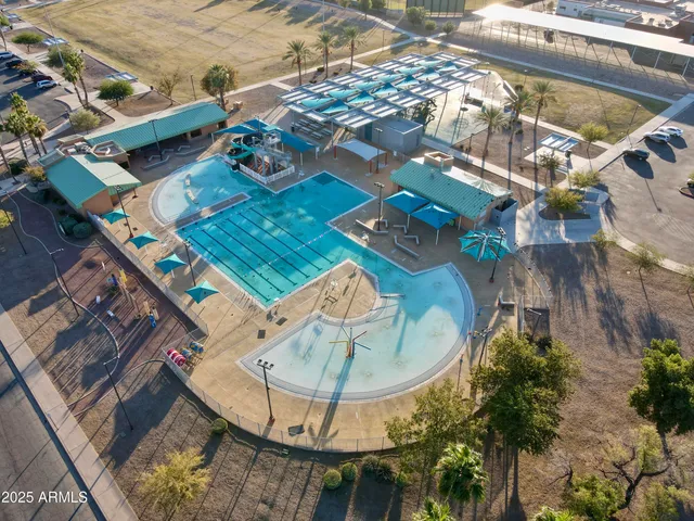 an aerial view of a house with a swimming pool