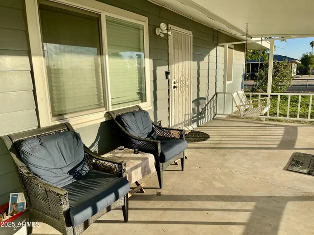 a view of a patio with table and chairs and potted plants