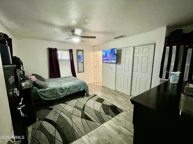 a bedroom with a bed and a large mirror