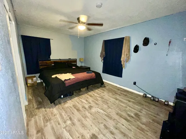 a bedroom with a bed and a chair