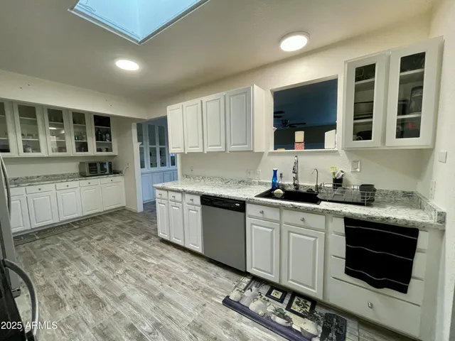 a kitchen with a sink stove top oven and cabinets