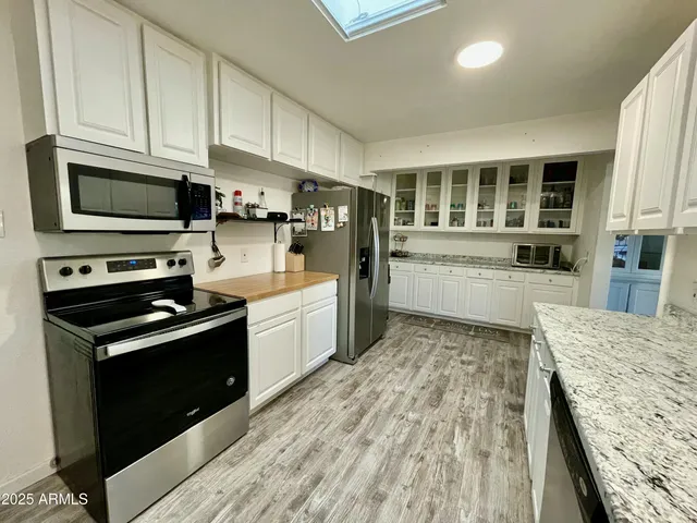 a kitchen with a stove a sink and a microwave