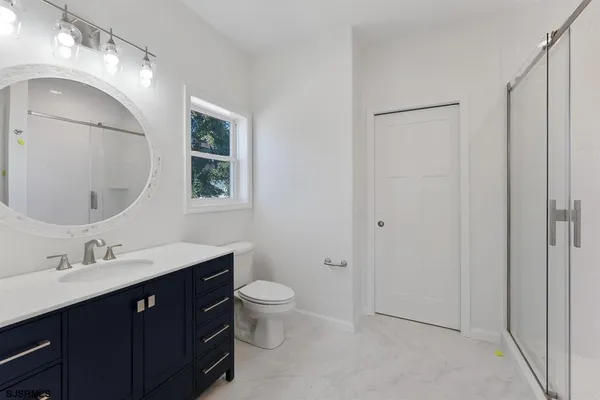 a bathroom with a toilet sink and mirror