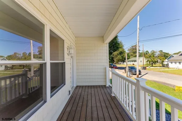 a view of a balcony with wooden floor