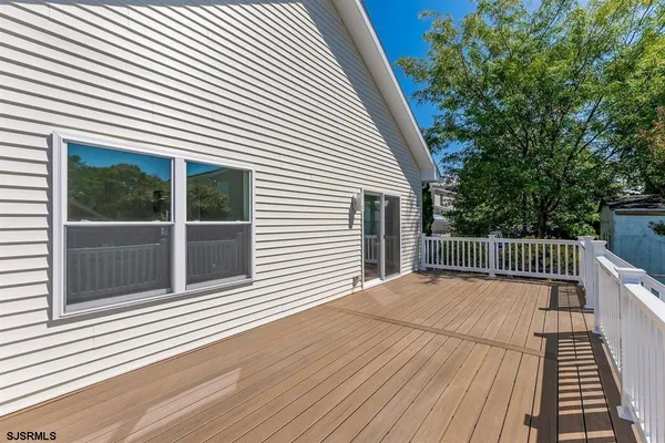 a view of backyard with a deck