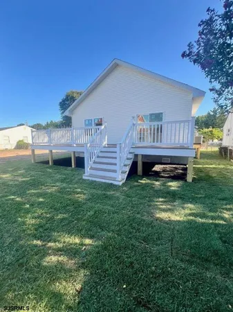 a view of a house with a backyard