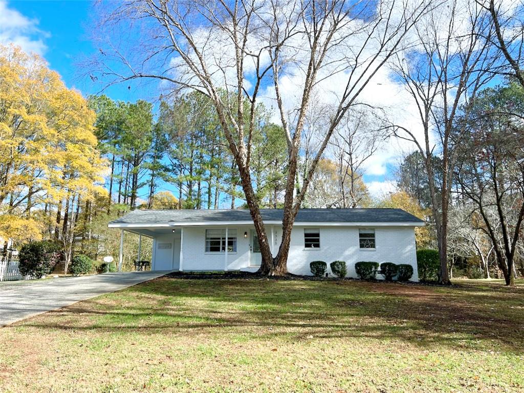 3335 Hopkins Road Powder Springs, GA 30127 - Photo 1 of 1 a view of a white house with a large tree and a yard with a large tree
