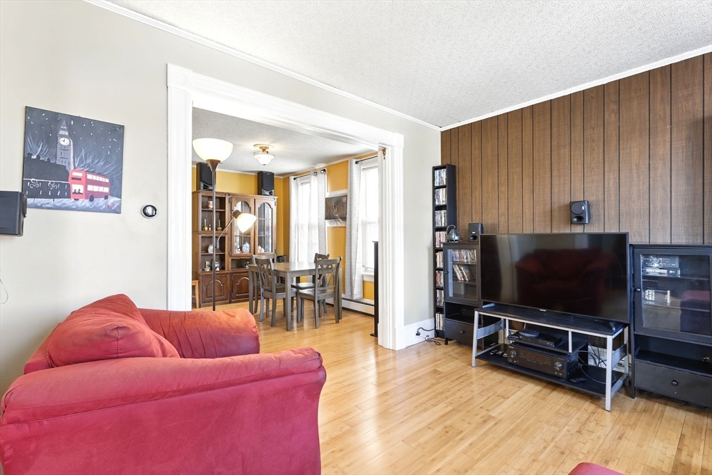 1014 Hampden Street Holyoke, MA 01040 - Photo 13 of 36 a living room with furniture and a flat screen tv