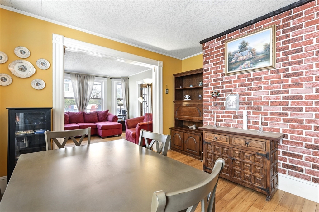 1014 Hampden Street Holyoke, MA 01040 - Photo 14 of 36 a living room with fireplace furniture and a large window