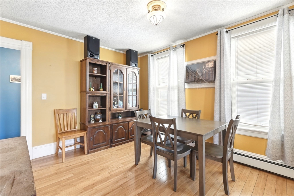 1014 Hampden Street Holyoke, MA 01040 - Photo 15 of 36 a view of a dining room with furniture and wooden floor