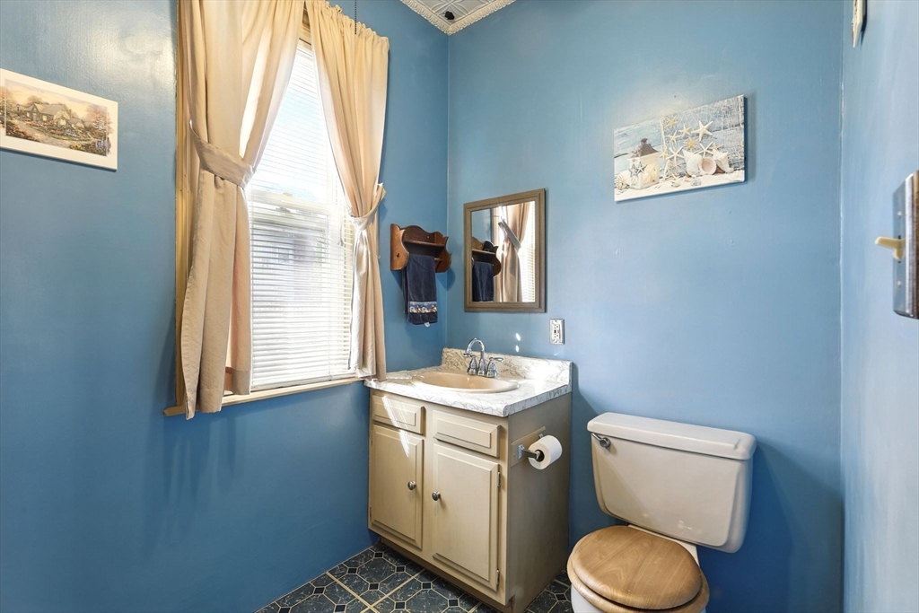 1014 Hampden Street Holyoke, MA 01040 - Photo 17 of 36 a bathroom with a toilet sink and mirror