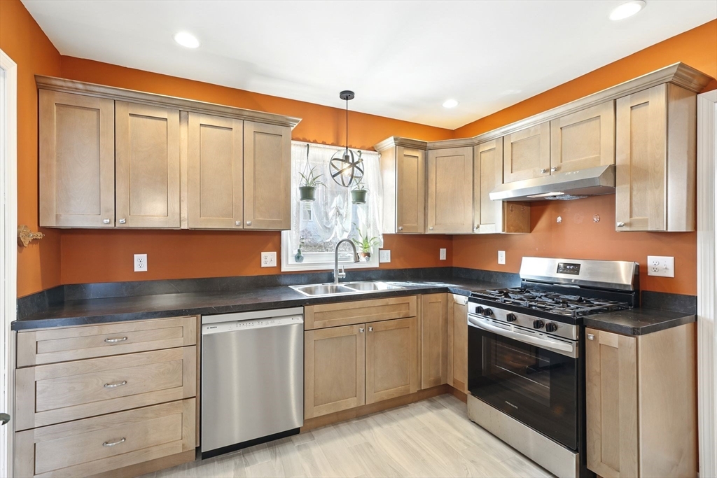 1014 Hampden Street Holyoke, MA 01040 - Photo 2 of 36 a kitchen with stainless steel appliances granite countertop a stove sink and cabinets