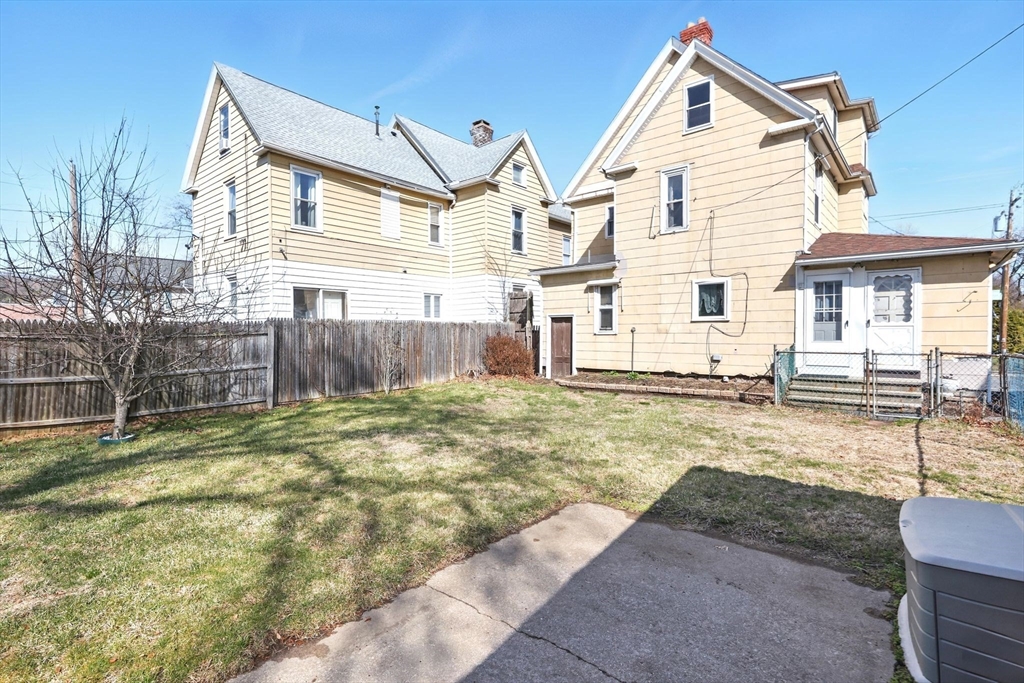 1014 Hampden Street Holyoke, MA 01040 - Photo 30 of 36 a view of a white house with a yard and lawn chairs