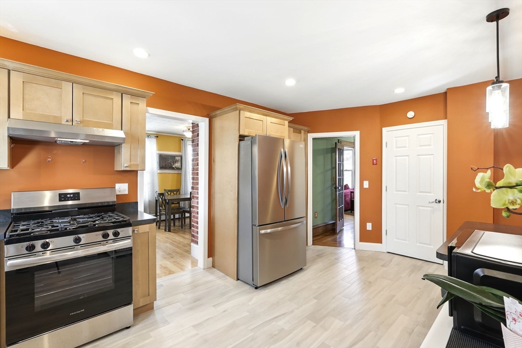 1014 Hampden Street Holyoke, MA 01040 - Photo 4 of 36 a kitchen with stainless steel appliances granite countertop a refrigerator stove and sink