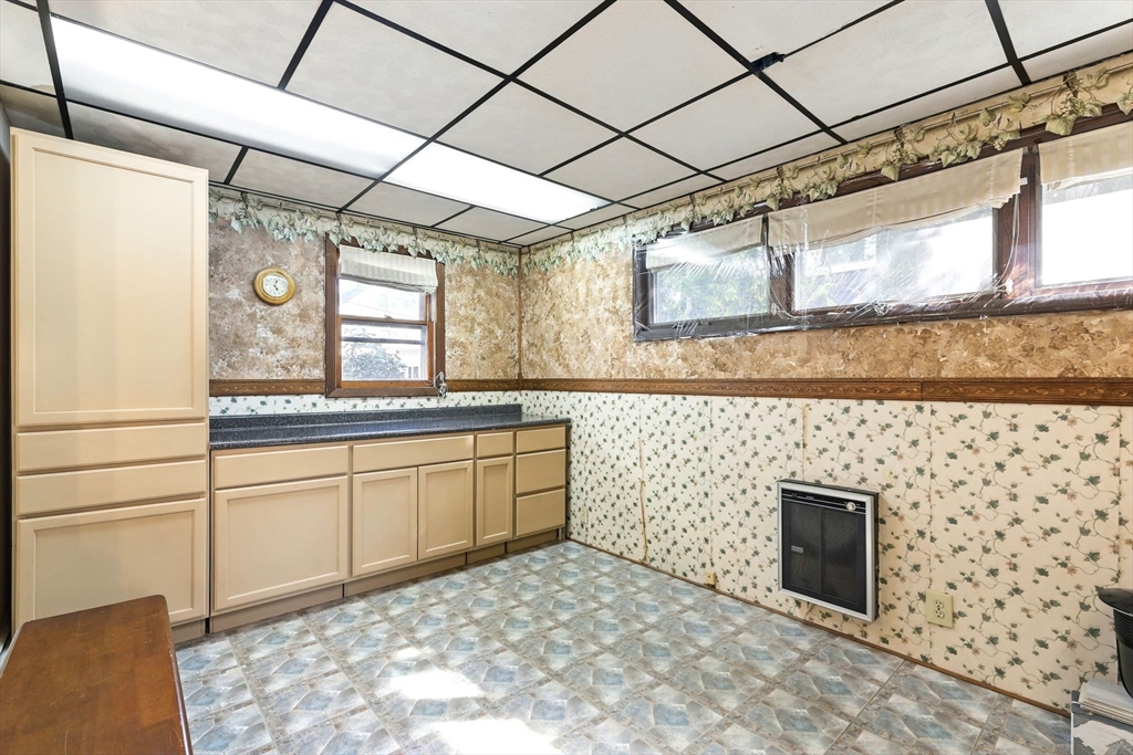 1014 Hampden Street Holyoke, MA 01040 - Photo 7 of 36 a bathroom with a granite countertop sink a toilet and a mirror