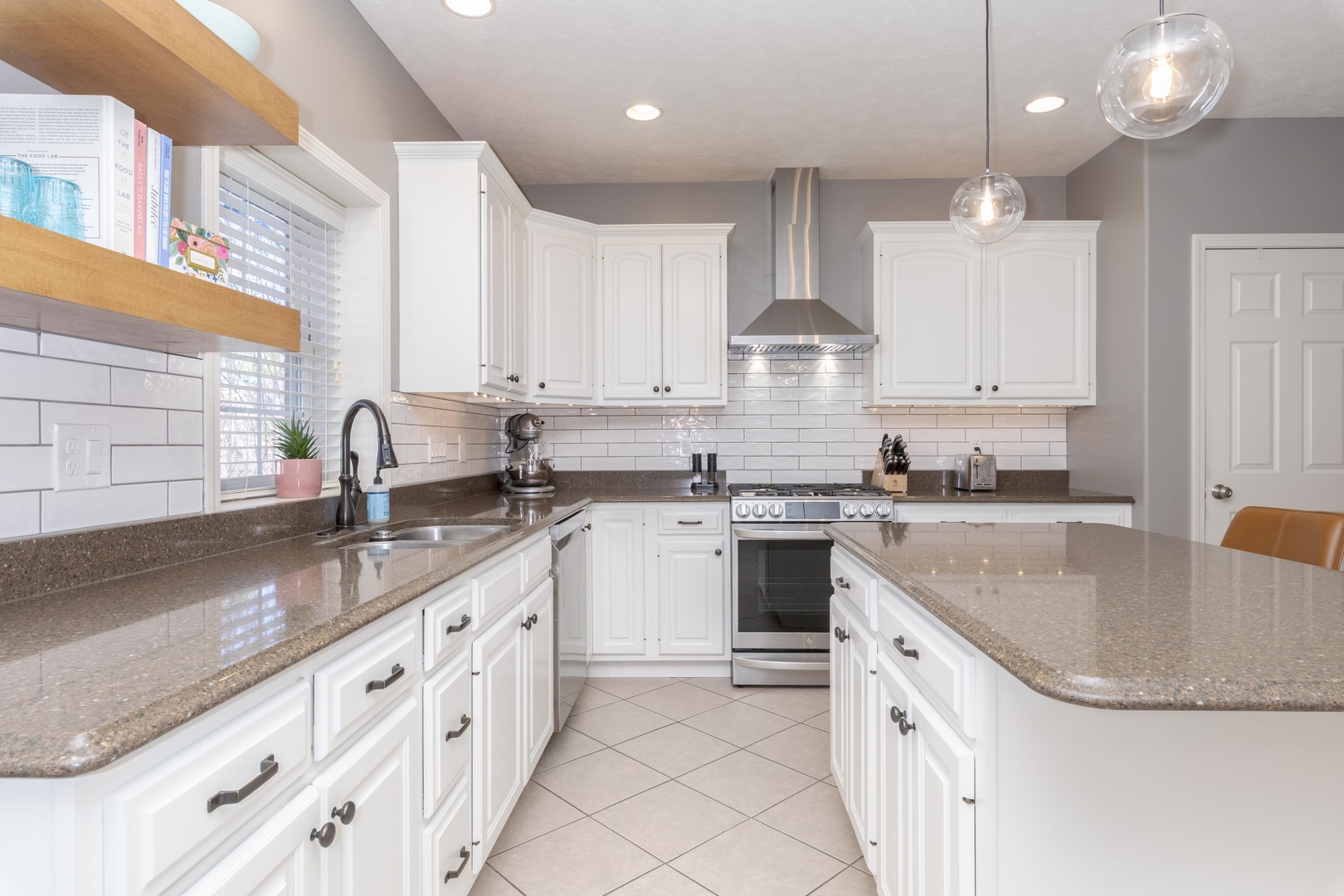 1223 Joy Walk Way Normal, IL 61761 - Photo 3 of 48 a kitchen with granite countertop a sink stove and cabinets