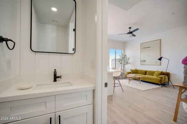 a living room with furniture and a wooden floor