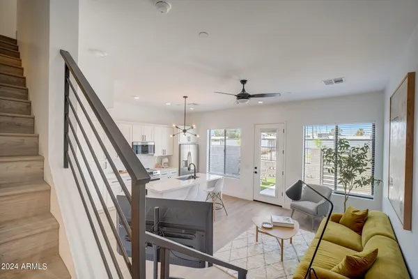 a living room with furniture and a chandelier