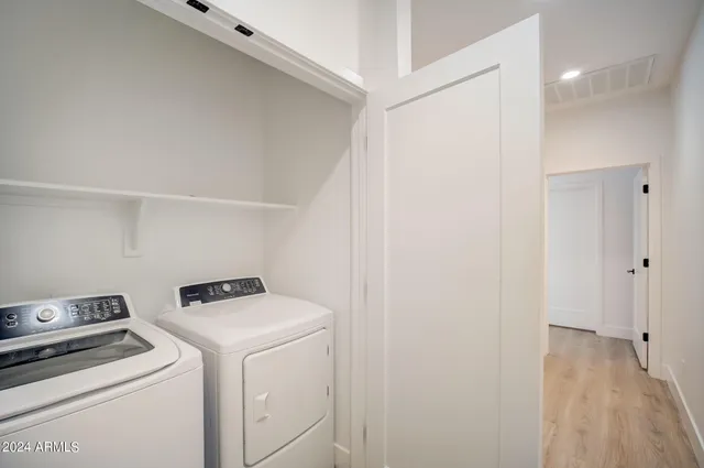 a view of storage and utility room with washer and dryer