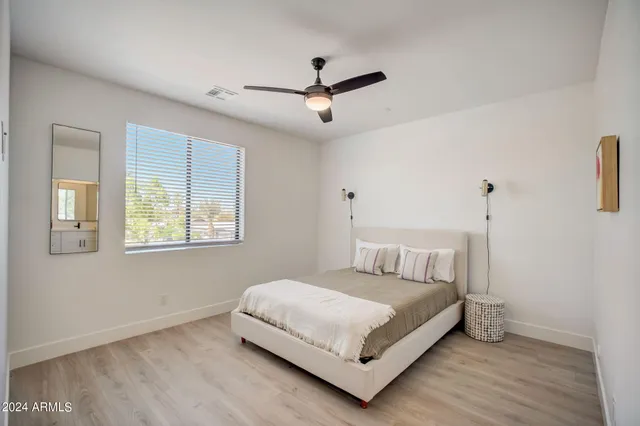 a bedroom with a bed and window