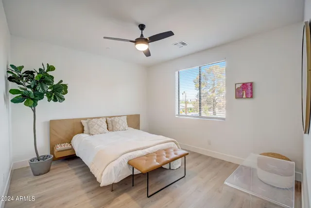 a bedroom with a bed and a potted plant