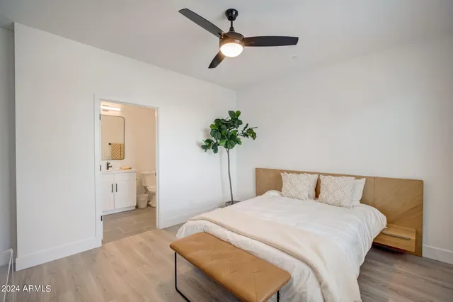 a bedroom with a bed and a potted plant