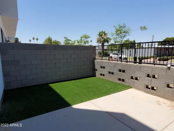 a view of a backyard with wooden fence