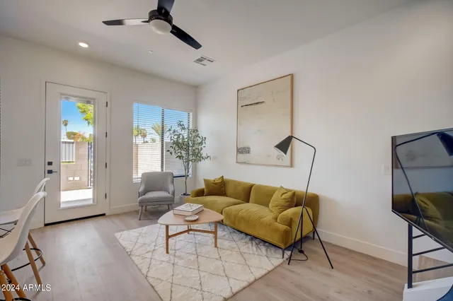 a living room with furniture and a wooden floor
