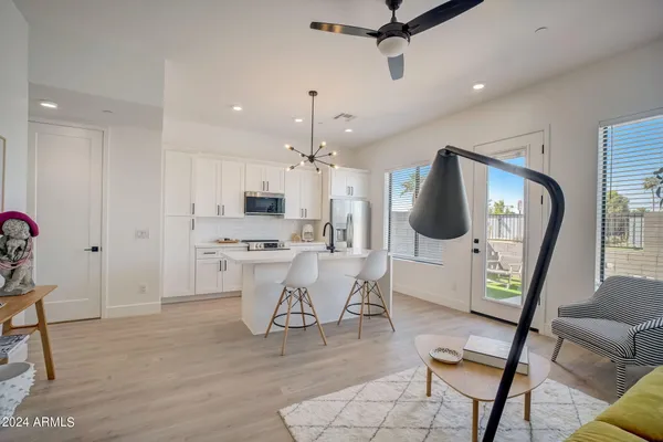 a view of kitchen with furniture and a refrigerator