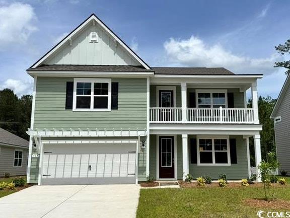 507 Slaty Drive Myrtle Beach, SC 29588 - Photo 1 of 23 Traditional-style house featuring a garage, concrete driveway, board and batten siding, a front lawn, and a balcony