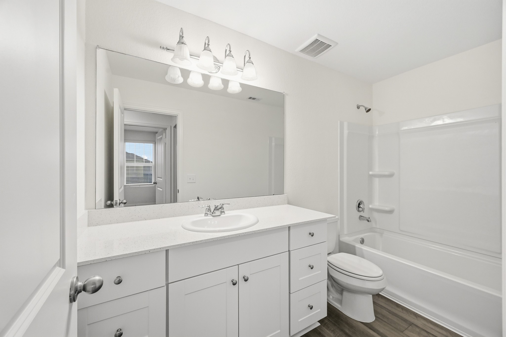 7207 Evitale Way Houston, TX 77049 - Photo 23 of 43 a bathroom with a toilet a sink a mirror a bathtub and shower