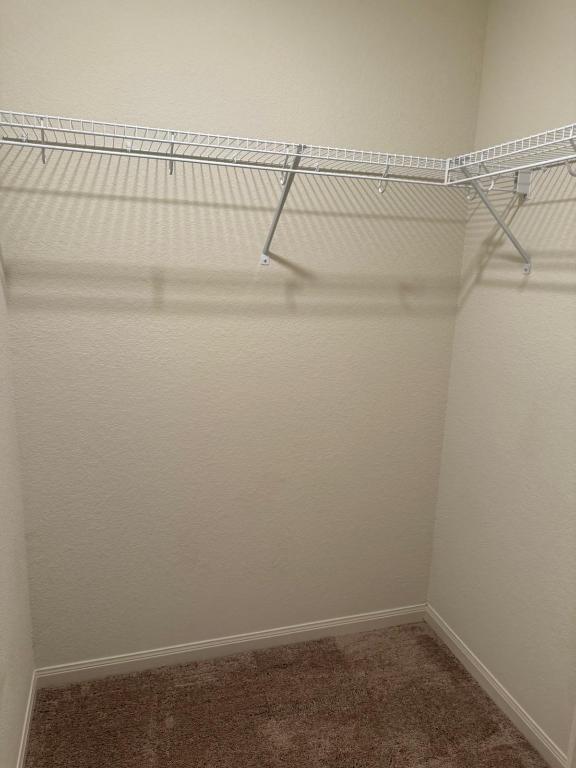 14325 Boomtown Way Elgin, TX 78621 - Photo 11 of 29 a view of a room with racks on the wall